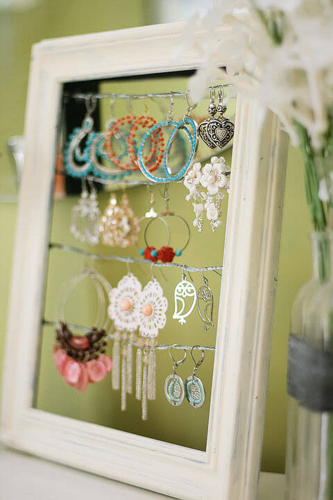 Get rid of the broken glass and turn your picture frame into an earring holder display.