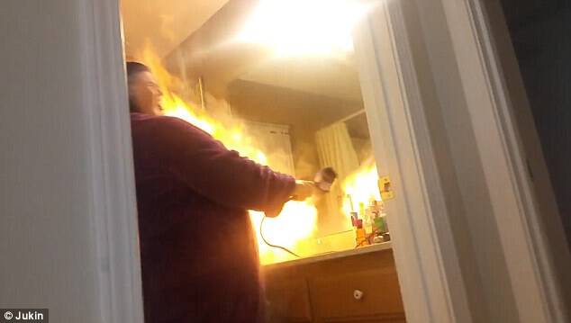 Up in flames! Her husband's laughter turns to horror after the hairdryer bursts into flames