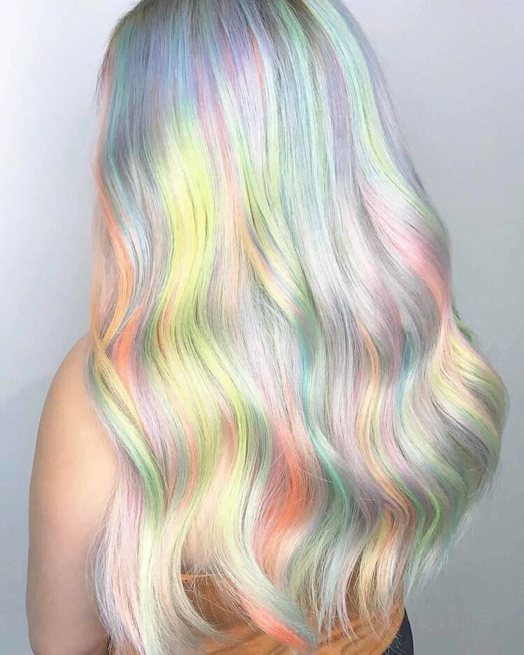 In order to accomplish this holographic hair look, hair colorists have been using a technique called hand-pressed coloring. 