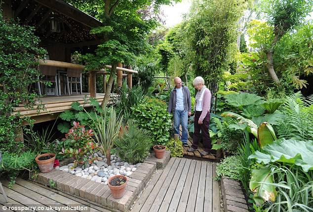The best things are worth waiting for: Nick Wilson shows his neighbour Sue Tuffin around the garden which has taken him 20 years to complete