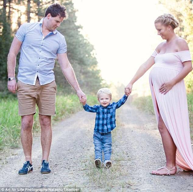 The mother - pictured with her husband Elliott, 34, and their son Noah, aged two - while pregnant with Darcy before his tragic stillbirth at 36 weeks 