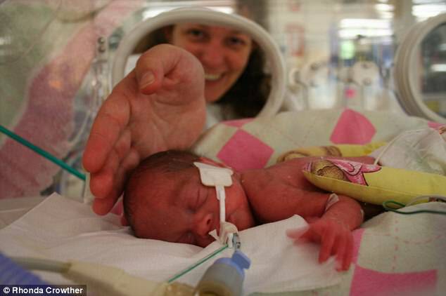 Baby girl Rachel Crowther (pictured in an incubator in 2007) was born prematurely weighing just 669 grams as her mother Rhonda smiles in the background 