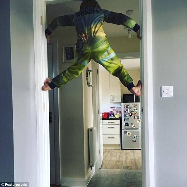 Six-year-old Ethan, described as 'amazingly agile' climbs up a doorway in his family home