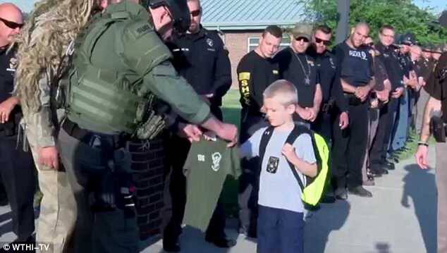 He was escorted by 70 of his father's coworkers while wearing his dad's badgeÂ 