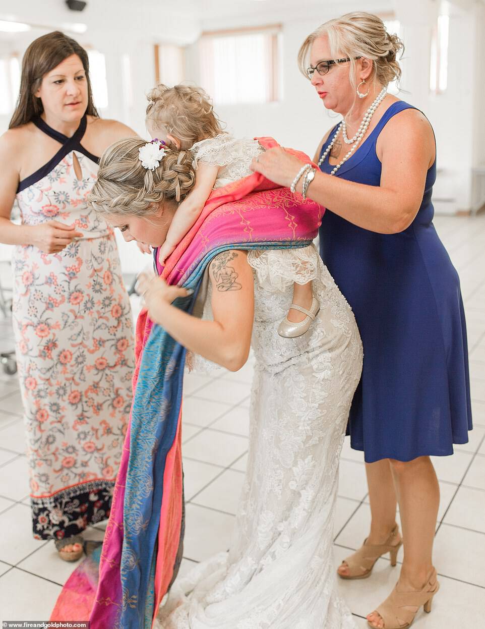 Memorable: Dalton's wedding photos were taken by Ohio-based photographerÂ Laura Schaefer of Fire and Gold Photography, who was eager to capture a shot of the moment Dalton put the baby on her back