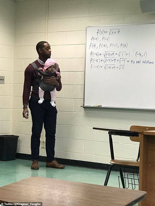 Nathan Alexander, a math professor at Morehouse College in Atlanta, was snapped in the Friday picture holding an adorable little girl while in class