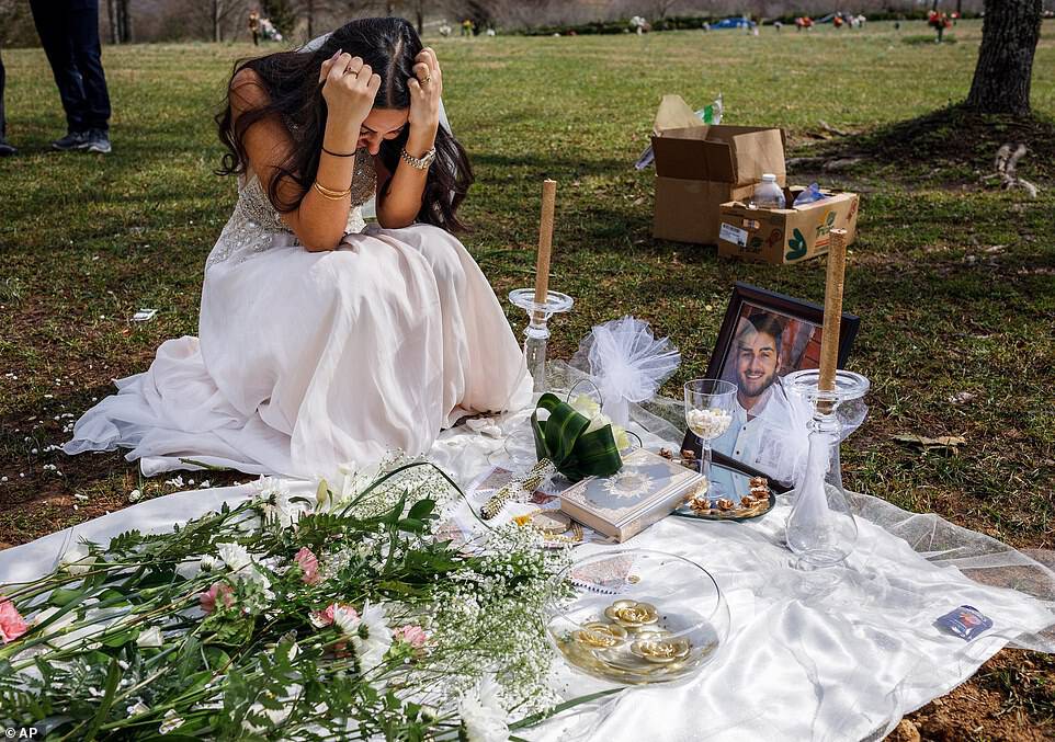 Sara Baluch, 22, is seen crying over the grave of her fiance Mohammad Sharifi on Sunday, three weeks after the 24-year-old was shot dead by a man he was selling an Xbox to. Baluch is wearing the white dress she was planning to wear at their wedding scheduled for Saturday